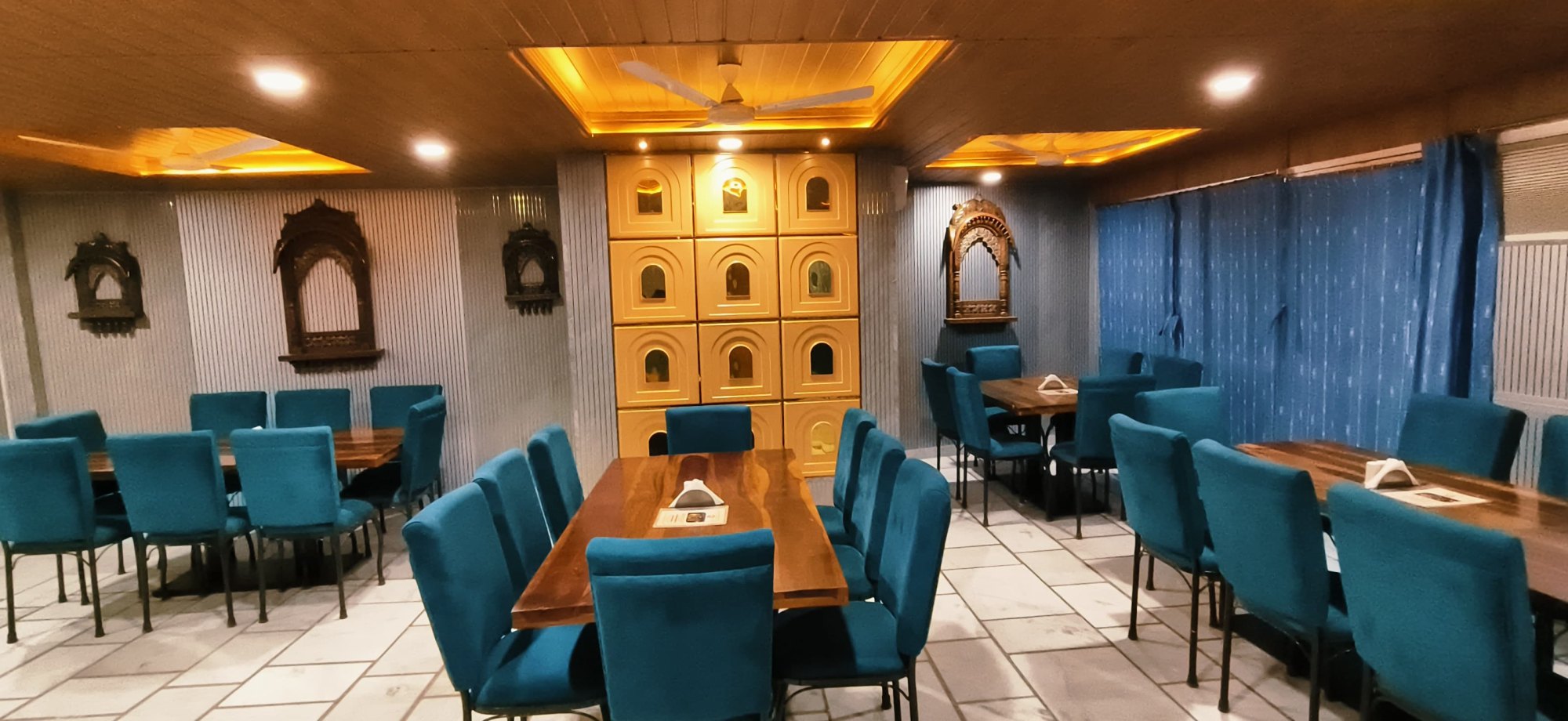 Dining hall at Hotel Moonlight with carved jharokha panels and warm lighting