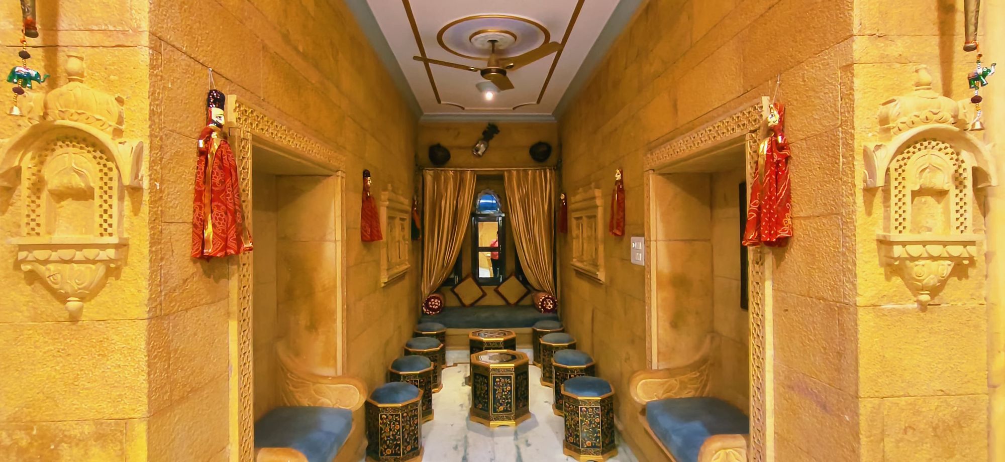 Carved sandstone corridor at Hotel Moonlight with jharokha niches