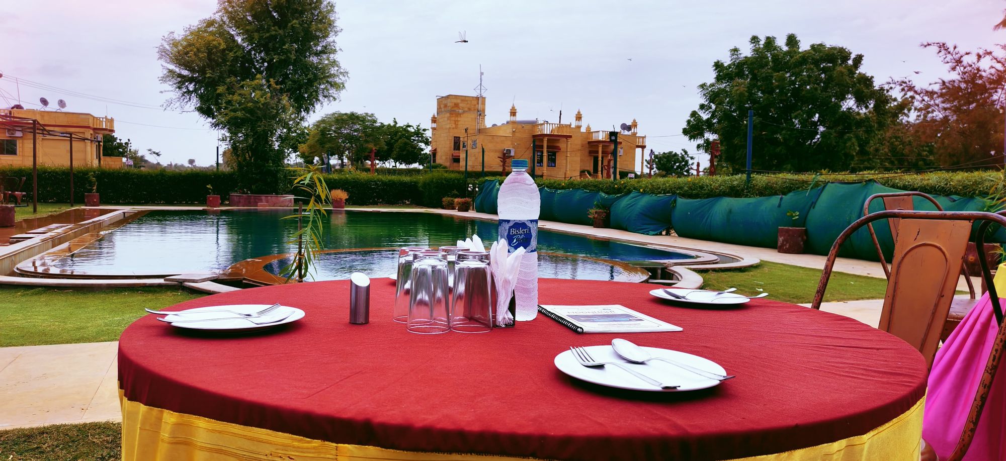 A table laid beside the pool at Moonlight Nature Resort